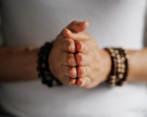 Woman hand yoga pose. Practicing meditation and praying indoors.